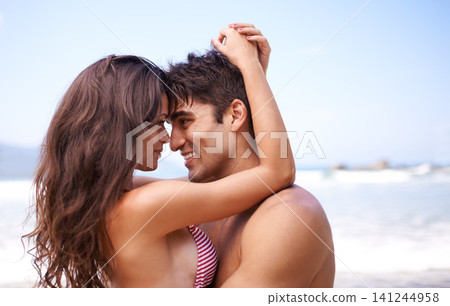 Love, hug and happy couple at ocean for tropical holiday adventure, relax and bonding together. Nature, man and woman smile on romantic date with beach, blue sky and embrace on vacation with mockup Love, hug and happy couple at ocean for tropical holiday adventure, relax and bonding together. Nature, man and woman smile on romantic date with beach, blue sky and embrace on vacation with mockup 141244958