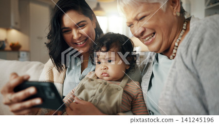 Selfie, woman and senior grandmother with baby bonding together on a sofa for relaxing at home. Happy, smile and female person taking a picture with elderly person in retirement with child in lounge. Selfie, woman and senior grandmother with baby bonding together on a sofa for relaxing at home. Happy, smile and female person taking a picture with elderly person in retirement with child in lounge. 141245196