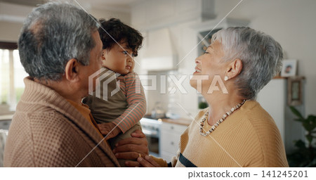 Smile, love and grandparents with grandchild at their home for bonding in the living room together. Happy, family and senior woman and man from Mexico with a baby, toddler or kid at modern house. Smile, love and grandparents with grandchild at their home for bonding in the living room together. Happy, family and senior woman and man from Mexico with a baby, toddler or kid at modern house. 141245201