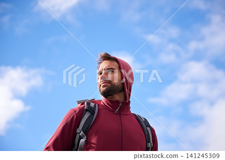 Outdoor, sky and man with backpack, thinking and nature for adventure, peace and travel. Contemplation, calm and male person in trip or vacation, thoughtful and journey for holiday and break 141245309