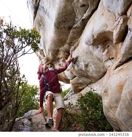 Man, mountain climbing and fitness for travel outdoor, freedom and journey with adventure, focus and strong. Determination, concentration and trekking with challenge, peak and rocks on rough terrain Man, mountain climbing and fitness for travel outdoor, freedom and journey with adventure, focus and strong. Determination, concentration and trekking with challenge, peak and rocks on rough terrain 141245316