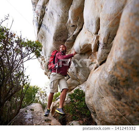 Man, mountain climbing and exercise for travel outdoor, freedom and journey with adventure, focus and strong. Determination, concentration and trekking with challenge, peak and rocks on rough terrain Man, mountain climbing and exercise for travel outdoor, freedom and journey with adventure, focus and strong. Determination, concentration and trekking with challenge, peak and rocks on rough terrain 141245332