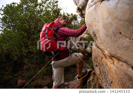 Rock climbing, hiking and man on mountain, nature and environment for outdoor adventure. Male person, athlete or sport in environment for exercise, fitness or health with backpack by plants in forest Rock climbing, hiking and man on mountain, nature and environment for outdoor adventure. Male person, athlete or sport in environment for exercise, fitness or health with backpack by plants in forest 141245333