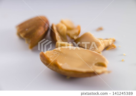 Almonds scattered on a white background; a still-life photograph of food ingredients and nutrients. Almonds scattered on a white background; a still-life photograph of food ingredients and nutrients. 141245389