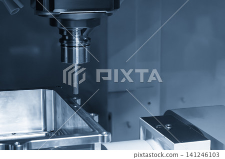 High-precision CNC milling machine performing a thread making process on an aluminum case part with a tapping tool. High-precision CNC milling machine performing a thread making process on an aluminum case part with a tapping tool. 141246103