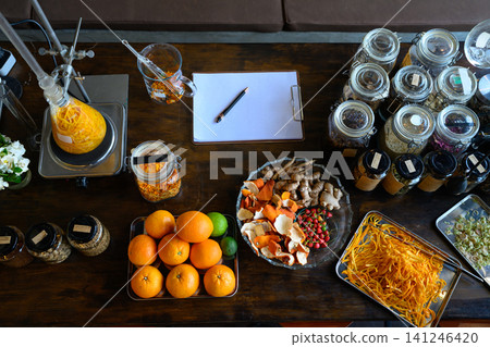 Herbal Apothecary Workstation with Citrus, Ginger, Spices and Laboratory Glassware on Wooden Table Herbal Apothecary Workstation with Citrus, Ginger, Spices and Laboratory Glassware on Wooden Table 141246420