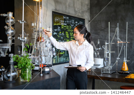 Young Asian Female Scientist Working with Distillation Equipment in Modern Chemistry Laboratory Young Asian Female Scientist Working with Distillation Equipment in Modern Chemistry Laboratory 141246447