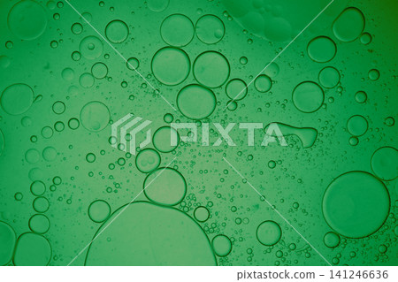 Green liquid showing abstract round oil and water bubbles forming a seamless texture Green liquid showing abstract round oil and water bubbles forming a seamless texture 141246636