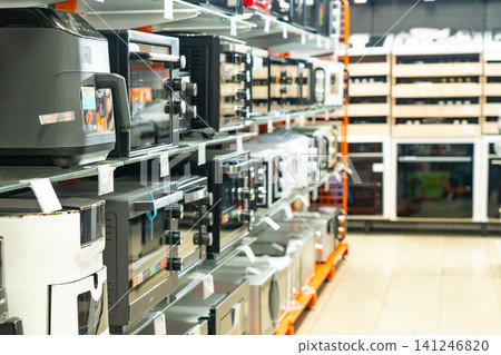 Exploring a Modern Display of Kitchen Appliances: A Visual Guide to the Latest Ovens, Microwaves, and Cooking Equipment in a Retail Setting 141246820