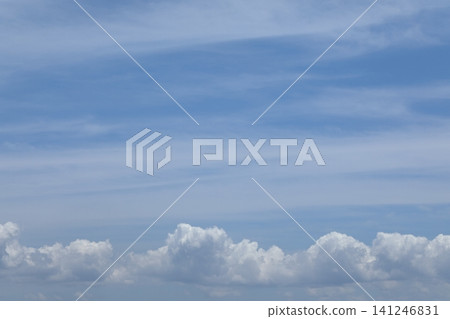 A landscape of white clouds spreading across a summer blue sky. 141246831