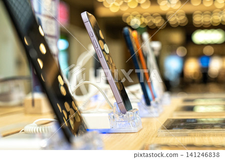 Showcasing a Range of Modern Smartphones in an Upscale Retail Environment with Focus on Innovative Technology and Sleek Designs Showcasing a Range of Modern Smartphones in an Upscale Retail Environment with Focus on Innovative Technology and Sleek Designs 141246838