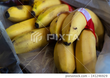 A Close-Up of Fresh, Ripe Bananas Stacked Together with a Touch of Natural Imperfection in a Practical Package A Close-Up of Fresh, Ripe Bananas Stacked Together with a Touch of Natural Imperfection in a Practical Package 141246929