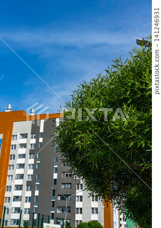 A Beautiful Urban Scene Featuring Lush Greenery and Modern Architectural Elements Under a Clear Blue Sky A Beautiful Urban Scene Featuring Lush Greenery and Modern Architectural Elements Under a Clear Blue Sky 141246931