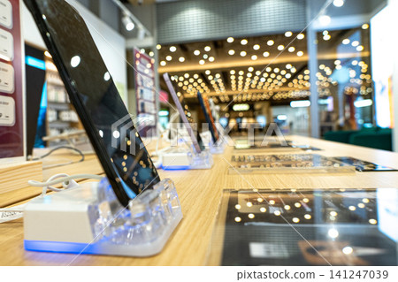 A Showcase of Cutting-Edge Smartphones in a Modern Retail Environment with Stylish Displays and Inviting Atmosphere A Showcase of Cutting-Edge Smartphones in a Modern Retail Environment with Stylish Displays and Inviting Atmosphere 141247039