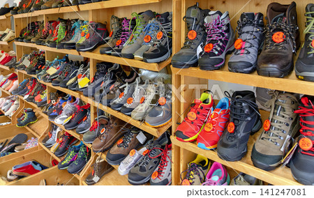 single hiking boots on a shelf 141247081