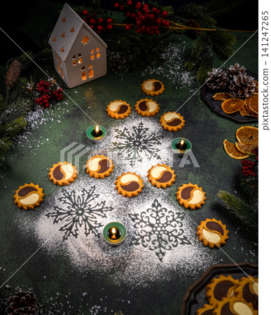 Christmas cookies and candles creating festive winter atmosphere Christmas cookies and candles creating festive winter atmosphere 141247265