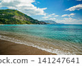 Azure Coastline with Ocean Waves Foam and Forested Hills Landscape 141247641