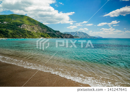 Azure Coastline with Ocean Waves Foam and Forested Hills Landscape Azure Coastline with Ocean Waves Foam and Forested Hills Landscape 141247641