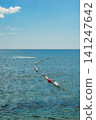 Red and Blue Safety Buoys Line in Clear Turquoise Sea Water 141247642