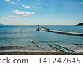 Motor Boat and Jet Skis at Floating Pier in Blue Sea on Summer Day 141247645