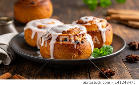 Fresh Baked Cinnamon Roll with Glossy White Sugar Glaze Icing Fresh Baked Cinnamon Roll with Glossy White Sugar Glaze Icing 141248475