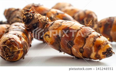 close-up of fresh turmeric roots on white background close-up of fresh turmeric roots on white background 141248551