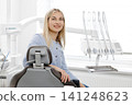 Patient smiling while sitting on dental chair in clinic 141248623