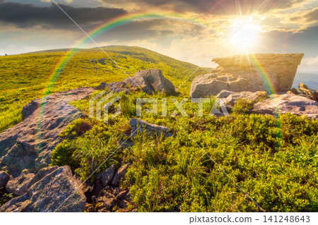 sunset over mountain landscape in summer. beautiful outdoor scenery of carpathian mountains. grassy slopes with rocks. image for ukraine travel background. weather with rainbow sunset over mountain landscape in summer. beautiful outdoor scenery of carpathian mountains. grassy slopes with rocks. image for ukraine travel background. weather with rainbow 141248643