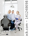 Mother and son smiling with dentist in dental clinic 141248698