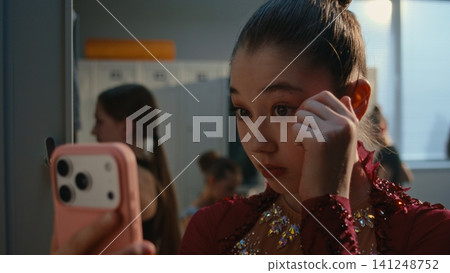 Confident Gymnast Checking Makeup and Taking Selfie in Dress Room Confident Gymnast Checking Makeup and Taking Selfie in Dress Room 141248752