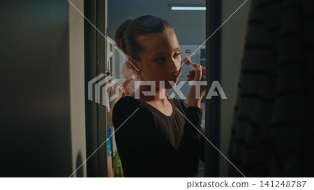 Young Gymnast in Black Training Outfit Carefully Touching Up Makeup Young Gymnast in Black Training Outfit Carefully Touching Up Makeup 141248787