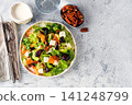 Healthy fresh salad with beet, feta cheese, oranges and pecans. Flat lay composition with cutlery and dressing on bright textured gray concrete background with copy space. Ideal for wellness blog 141248799