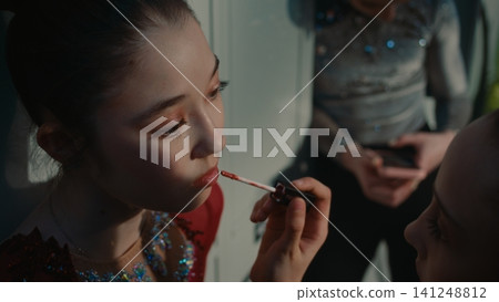 Teenage Rhythmic Gymnast Applies Lipstick to Teammate Using Soft Applicator Teenage Rhythmic Gymnast Applies Lipstick to Teammate Using Soft Applicator 141248812