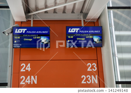 Warsaw, Poland, May 10 2018: Departure screen at gate for flight to the USA Warsaw, Poland, May 10 2018: Departure screen at gate for flight to the USA 141249148