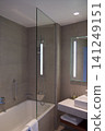 Wroclaw, Poland, June 15, 2018: Bathtub and shower with glass splash guard in luxury hotel bathroom 141249151