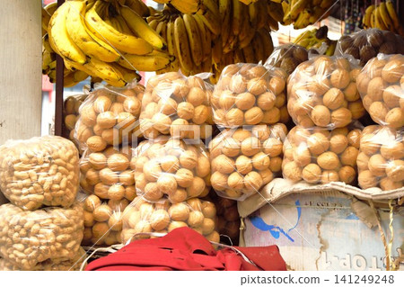 Bananas, walnuts, and peanuts on display at a local market in Pokhara, Nepal. Bananas, walnuts, and peanuts on display at a local market in Pokhara, Nepal. 141249248