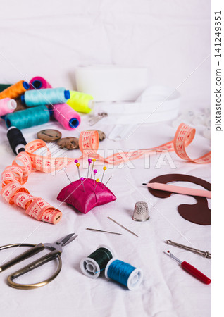 Sewing accessories for sewing and needlework on the table vertical view Sewing accessories for sewing and needlework on the table vertical view 141249351