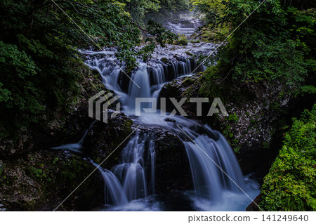 A mystical valley bathed in the soft morning light, and a dynamic waterfall landscape. 141249640
