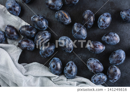 Fresh plums in a clay bowl. Fresh plums in a clay bowl. 141249816