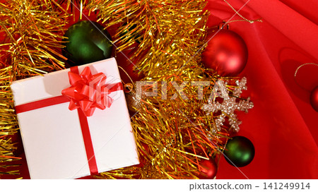 A white box with a red ribbon, a Christmas present. A white box with a red ribbon, a Christmas present. 141249914