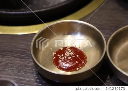 Sesame Seed Topped Red Sauce in Metal Bowl Sesame Seed Topped Red Sauce in Metal Bowl 141250173
