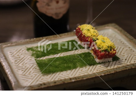 Garnished Sushi Morsels on Decorative Plate Garnished Sushi Morsels on Decorative Plate 141250179
