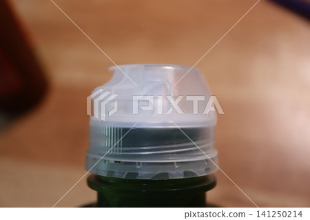 Close-Up of Plastic Bottle Cap on Green Container Close-Up of Plastic Bottle Cap on Green Container 141250214