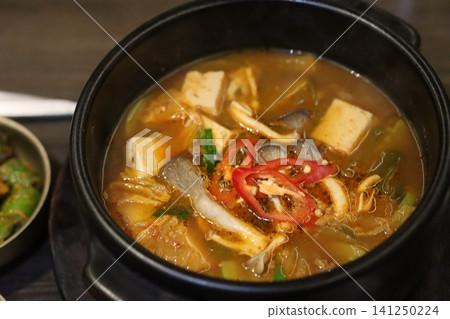 Steaming Tofu and Mushroom Hot Pot in Black Pot Steaming Tofu and Mushroom Hot Pot in Black Pot 141250224