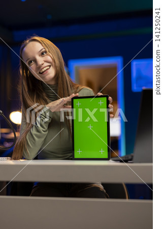 Vertical mockup screen on tablet next to vlogger filming lifestyle video, using camera and microphone at home. Girl content creator create engaging content for social platforms, fun hobby. 141250241