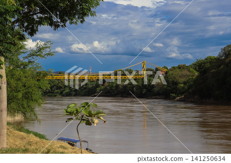 Mariano Ospina Perez Bridge and the Magdalena River as it passes through Girardot Cundinamarca and Flandes Tolima, taken from the Port of Los Guamos in Girardot. Mariano Ospina Perez Bridge and the Magdalena River as it passes through Girardot Cundinamarca and Flandes Tolima, taken from the Port of Los Guamos in Girardot. 141250634