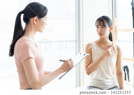 A woman with a troubled expression is being solicited for Pilates. A woman with a troubled expression is being solicited for Pilates. 141251357