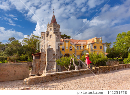Historic villa with stone tower in Cascais, Portugal under dramatic cloudy sky Historic villa with stone tower in Cascais, Portugal under dramatic cloudy sky 141251758
