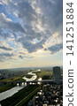 A panoramic view of the river and cityscape illuminated by the setting sun. 141251884