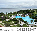 A tropical resort in the Philippines overlooking the ocean and a large swimming pool. 141251947